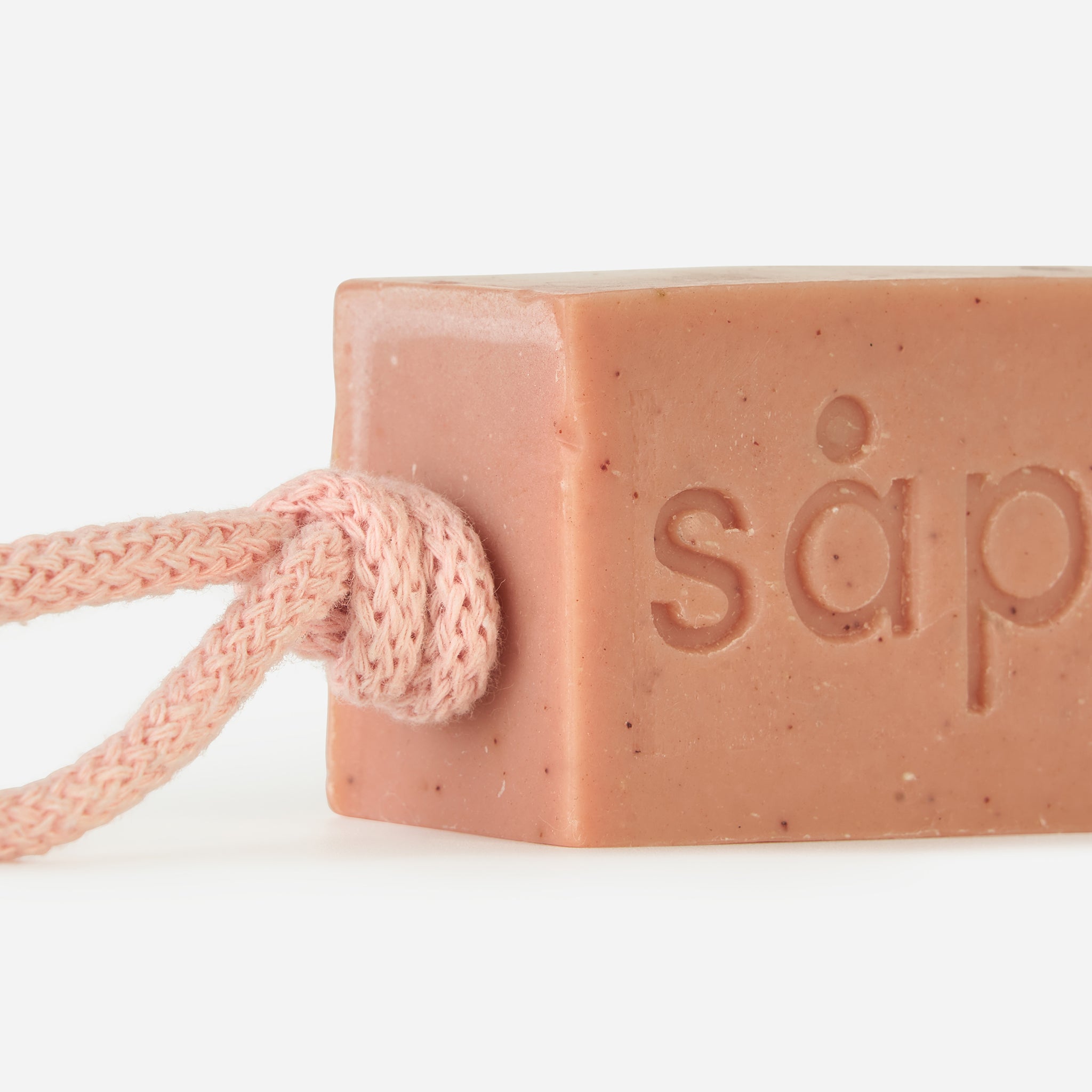 Close-up of Drøm handmade soap with visible exfoliating particles and rope