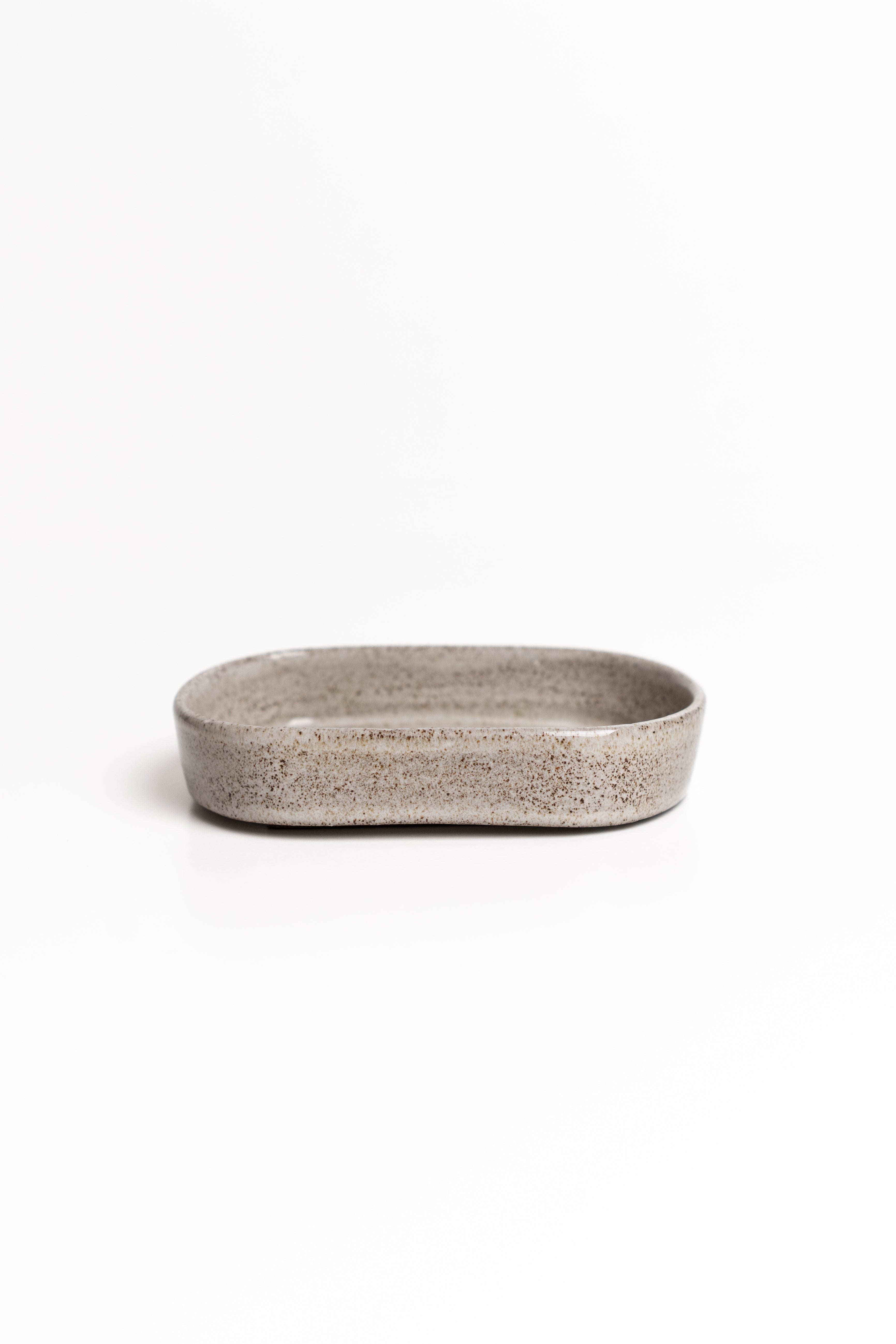 Rectangular ceramic dish with textured surface on a white background