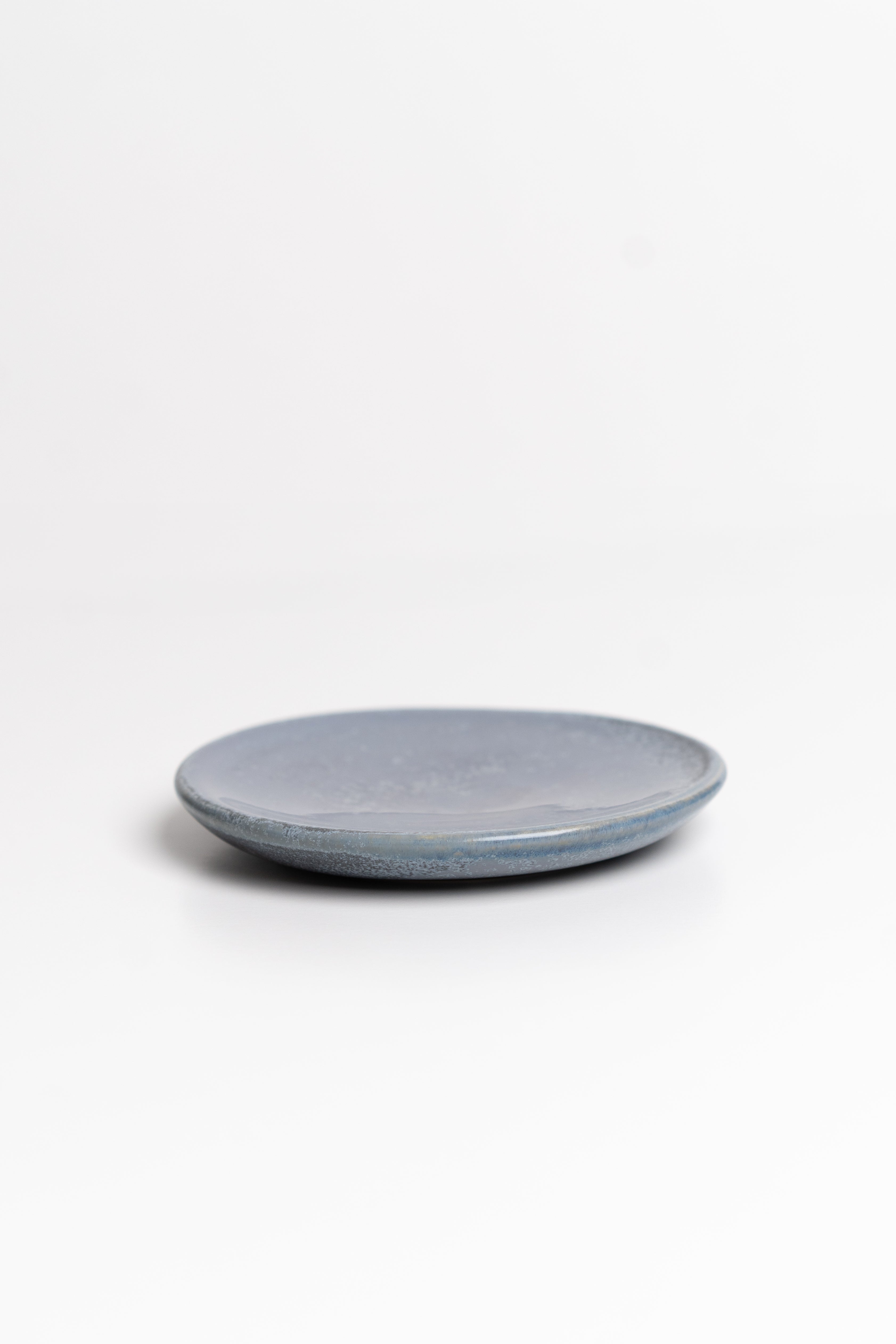 Blue round ceramic dish on a white background