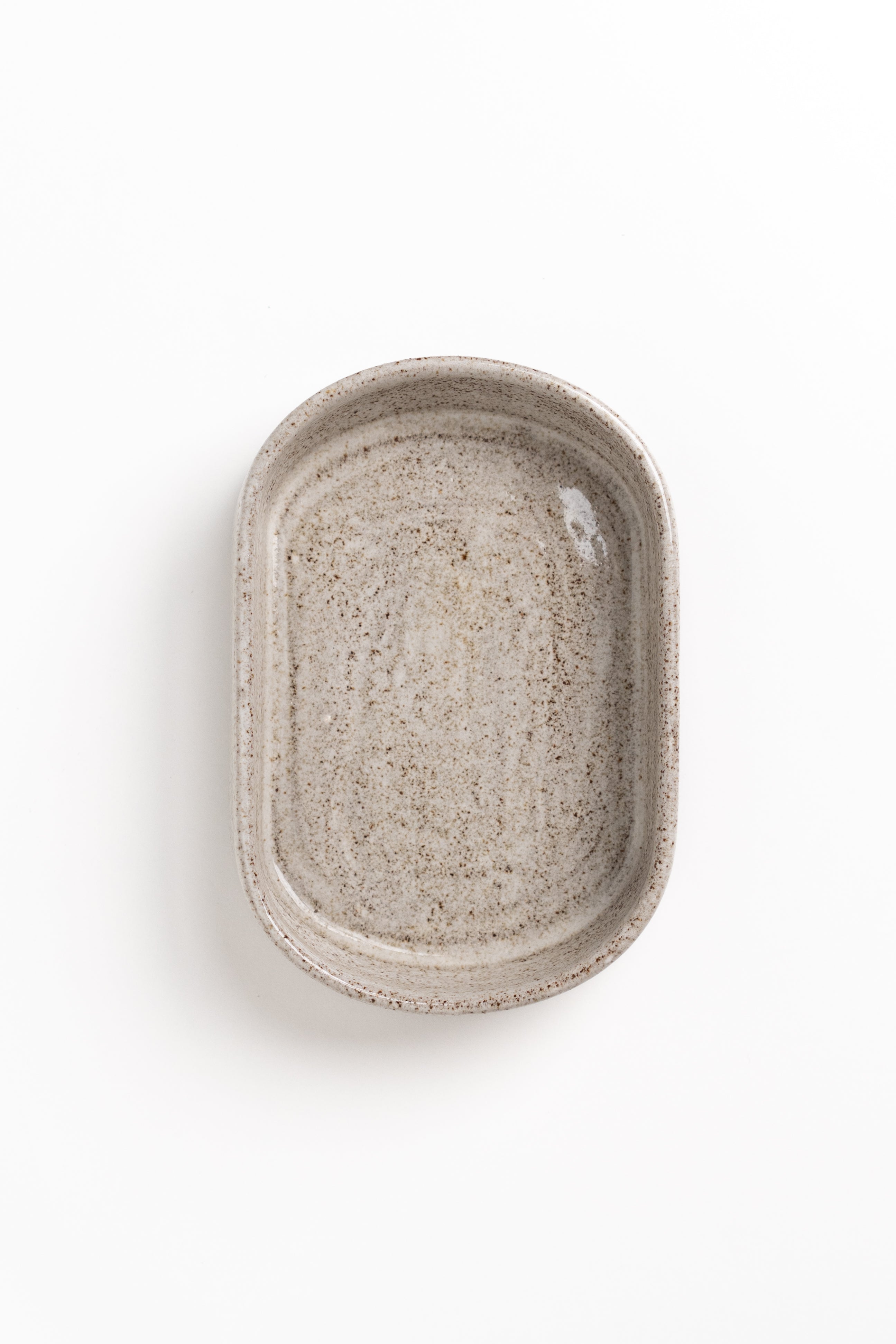 Rectangular ceramic dish with a textured surface on a white background