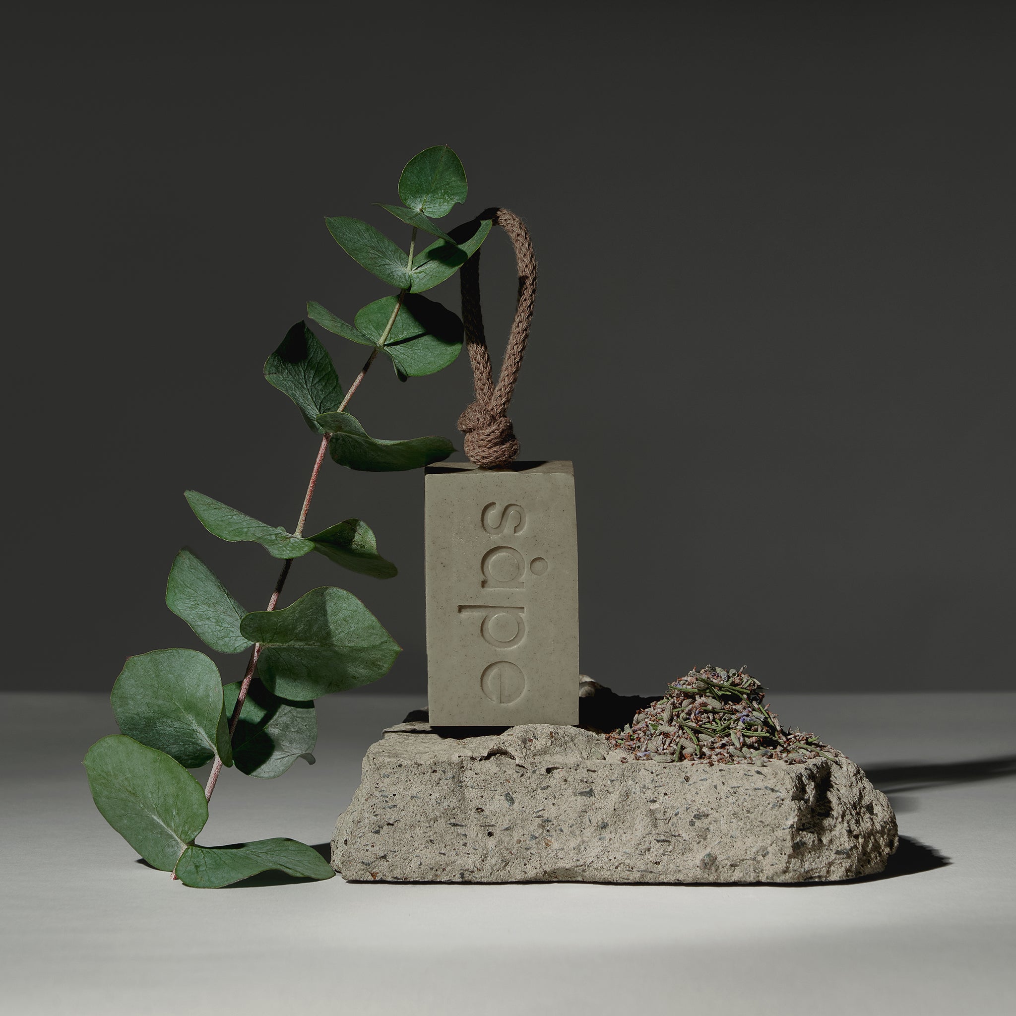 Grey Bris soap styled with eucalyptus and lavenders on natural stone