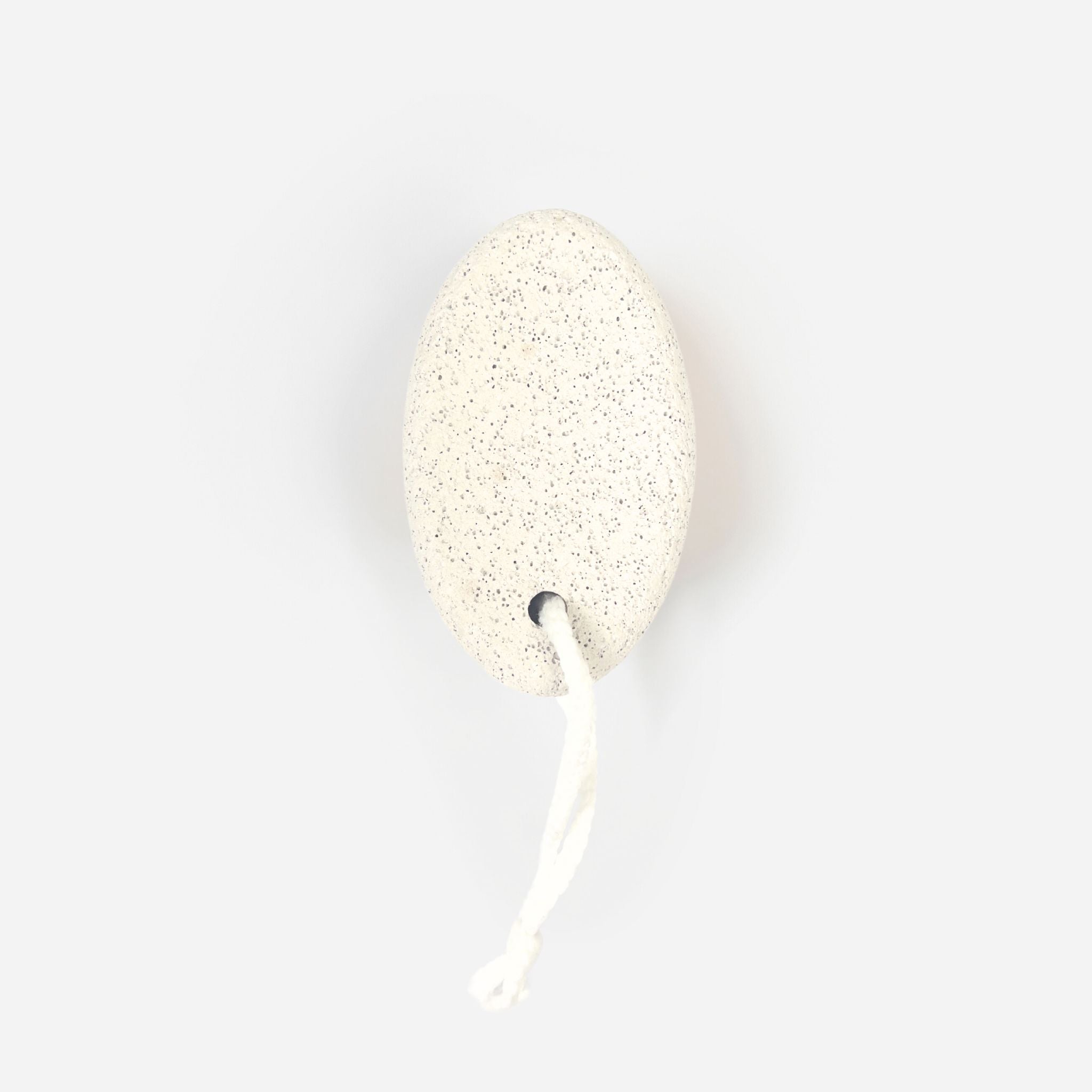 Natural volcanic pumice stone, highlighting its porous texture and ergonomic shape for exfoliating feet and hands.