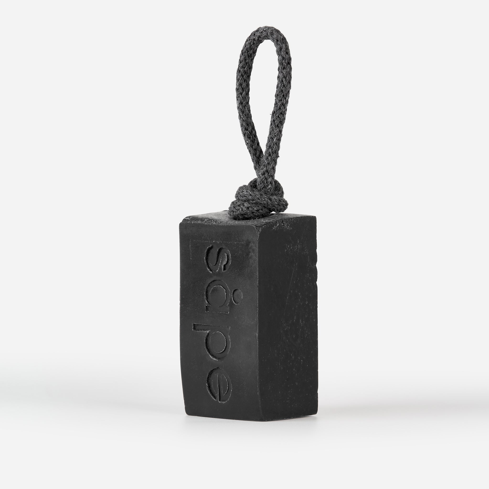 Side view of Myrk charcoal soap with rope – natural soap for oily skin UK