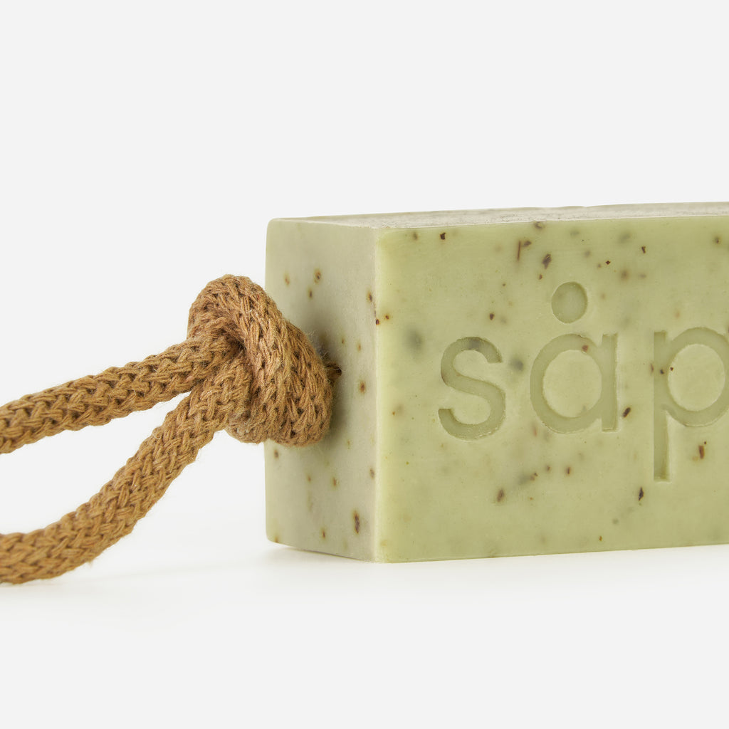 Close-up of Frisk handmade soap showing mint leaf flecks and rope detail