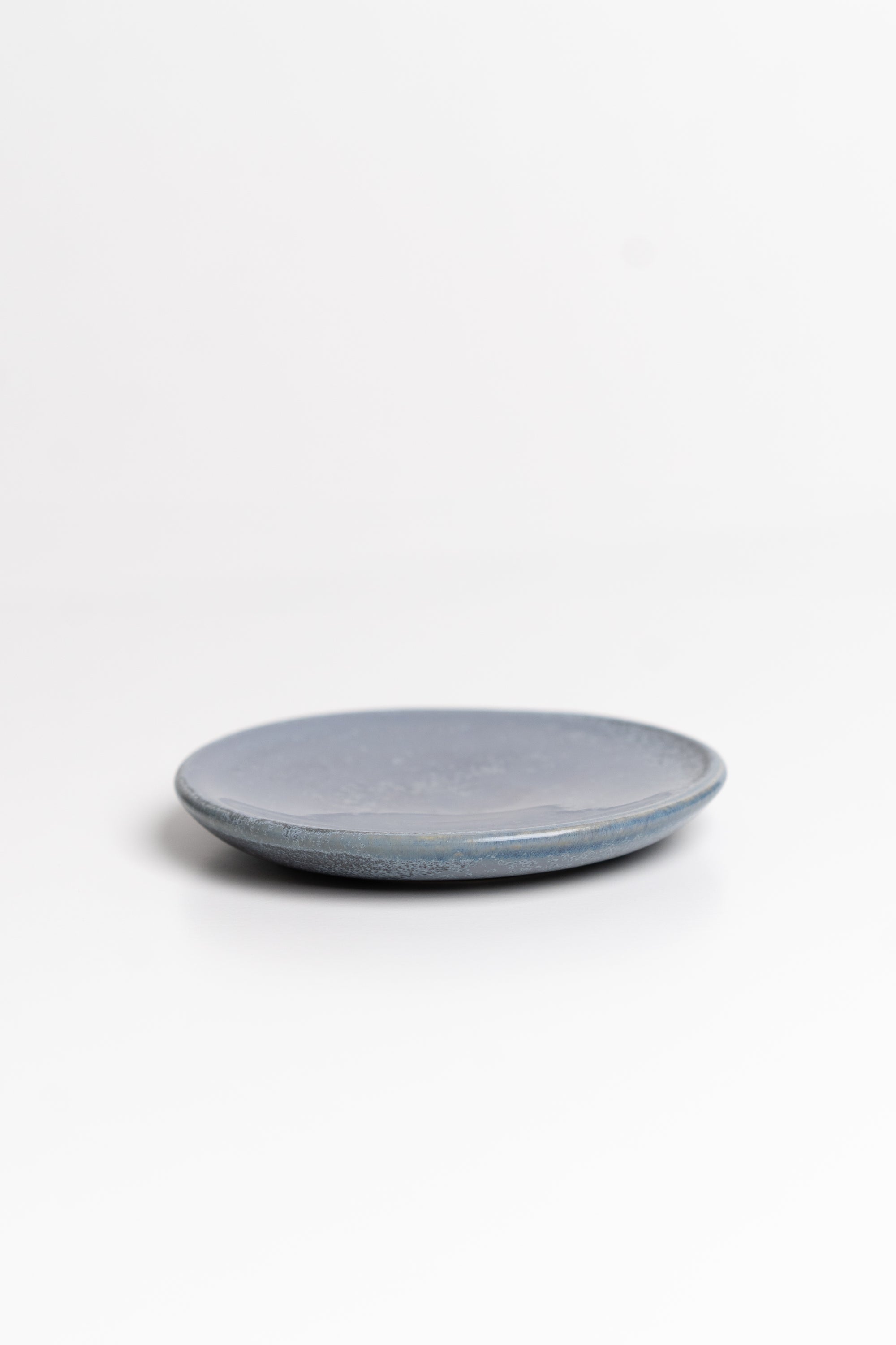 Blue round ceramic dish on a white background