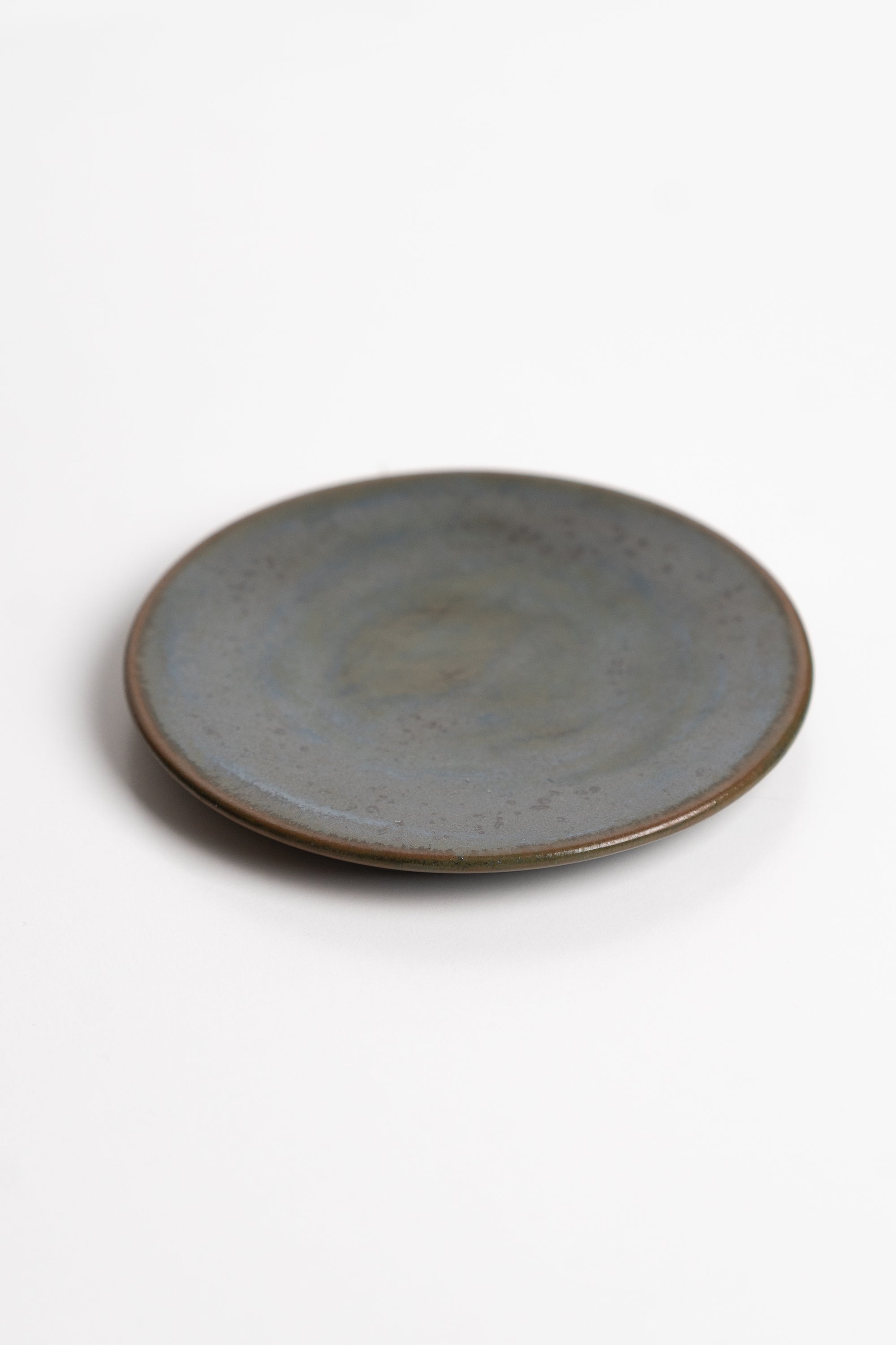 Round ceramic dish with a textured surface on a white background