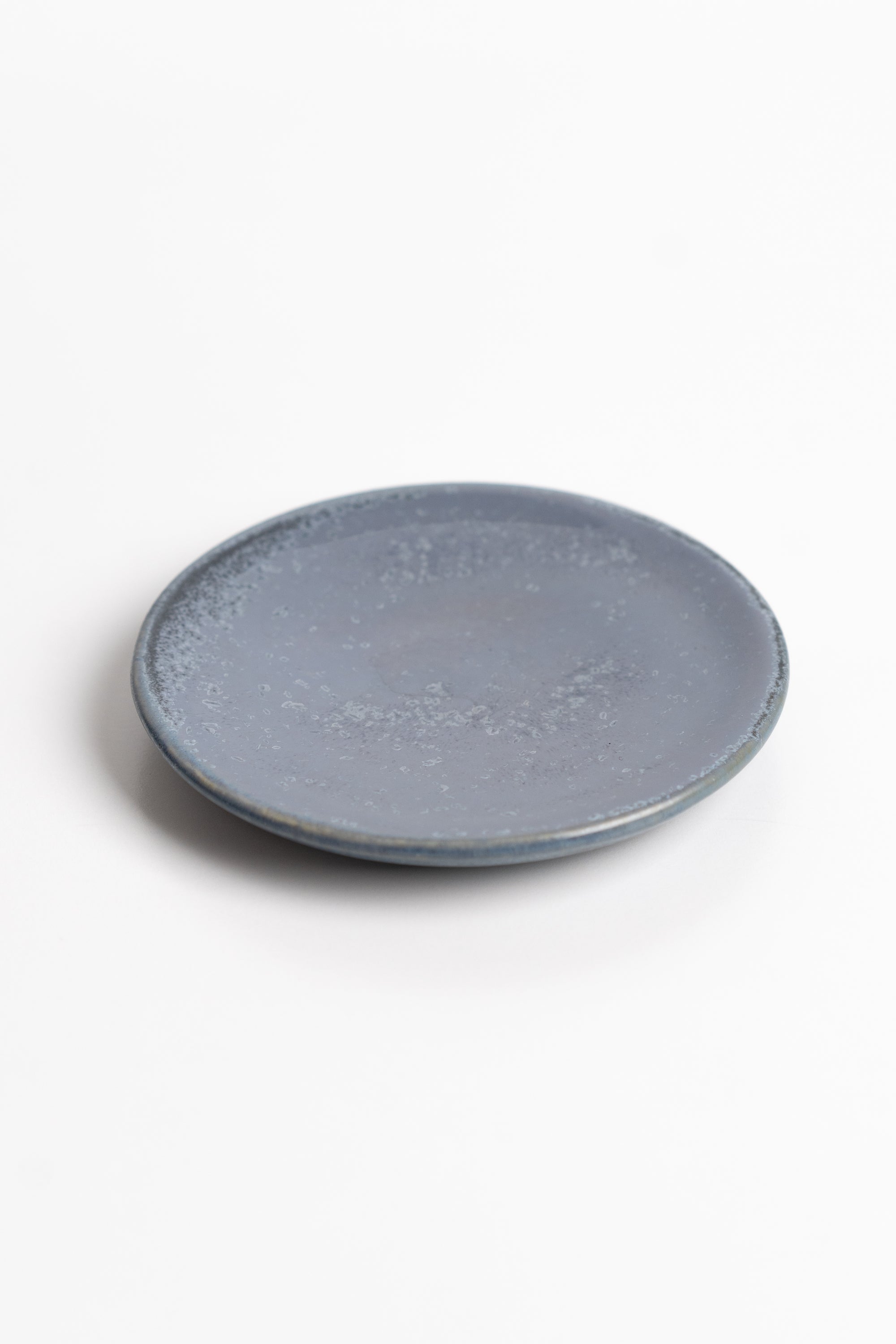 Round blue ceramic dish on a white background