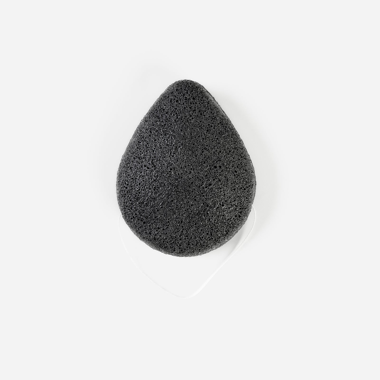 Front view of Charcoal Konjac Sponge with white hanging string, teardrop shape