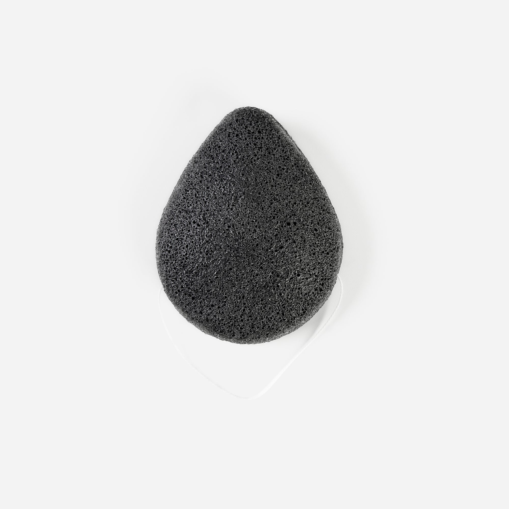 Front view of Charcoal Konjac Sponge with white hanging string, teardrop shape