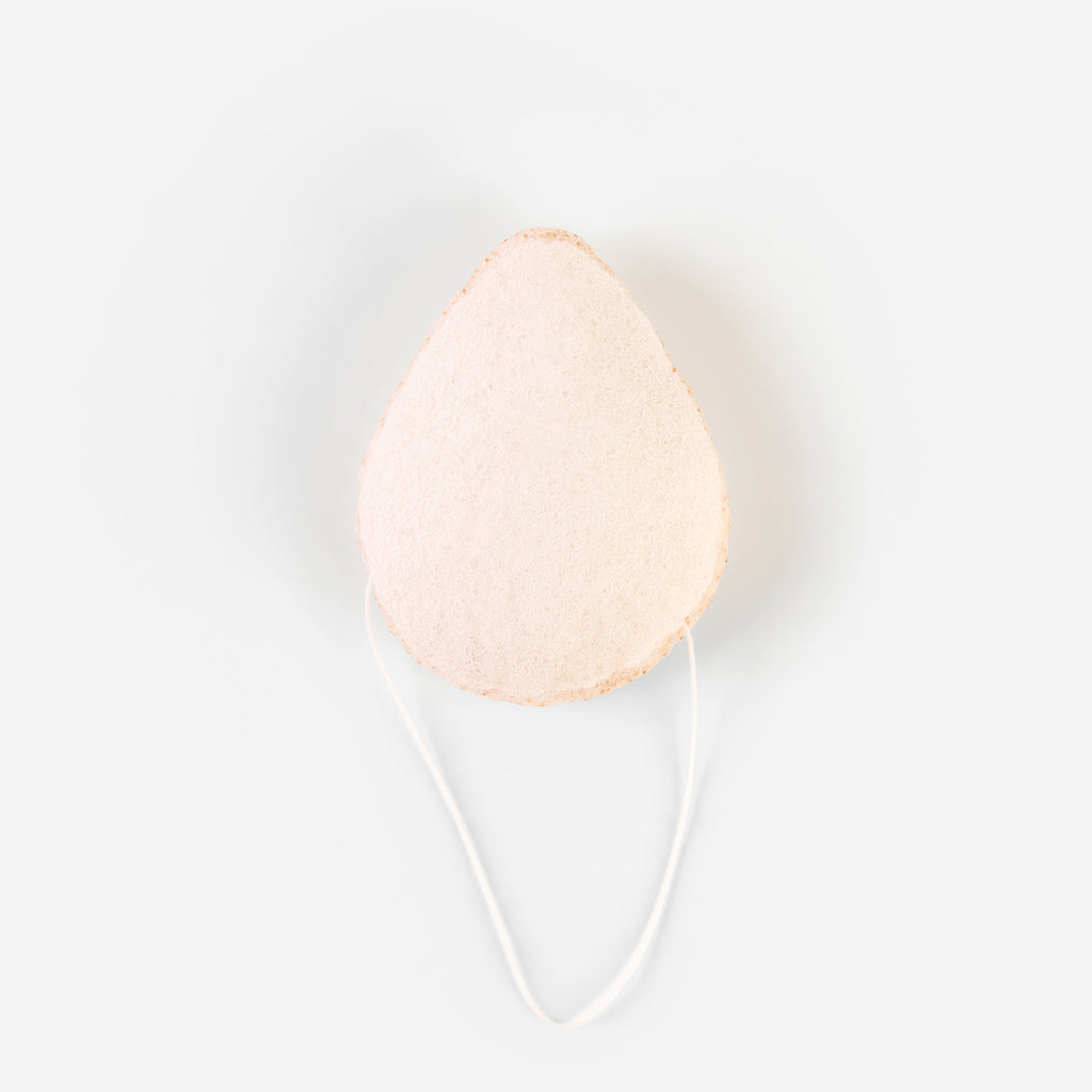 Front view of walnut-infused Konjac Sponge with white string for hanging
